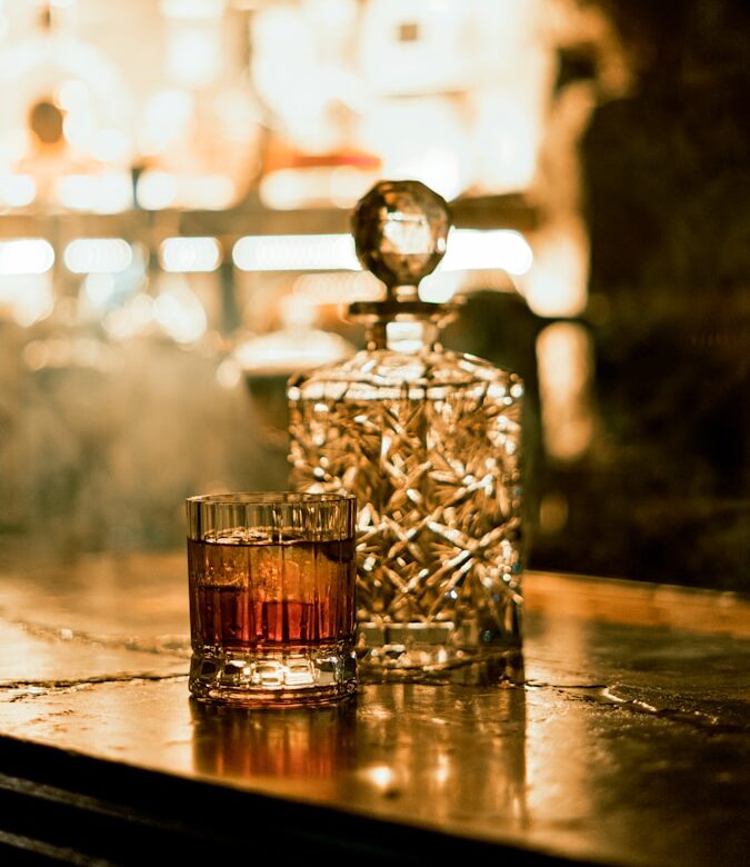 a glass of whiskey sitting on top of a table